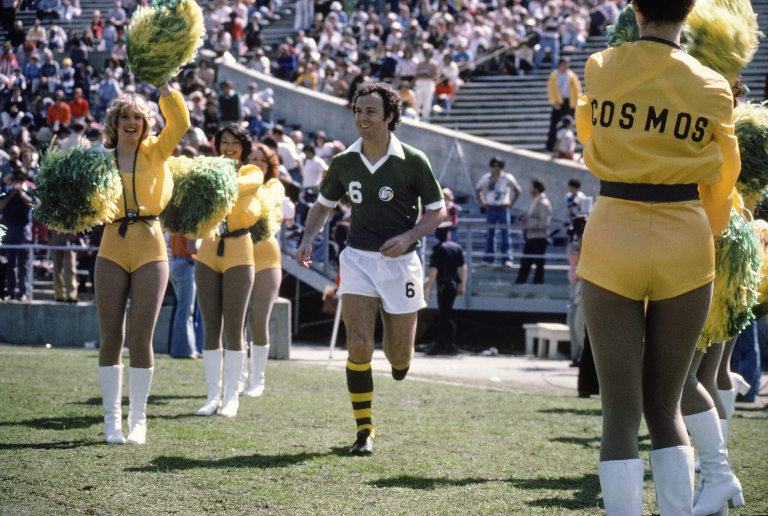 Franz Beckenbauer runs out between the cheerleaders for New York Cosmos at the Rose Bowl in April, 1978