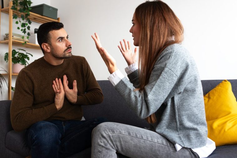 Young couple having an argument. Woman is angry with man. - stock photo