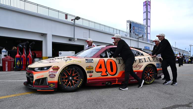 Crew members push Justin Allgaier's No. 40 Chevrolet through the Daytona garage area during the 2026 NASCAR season.