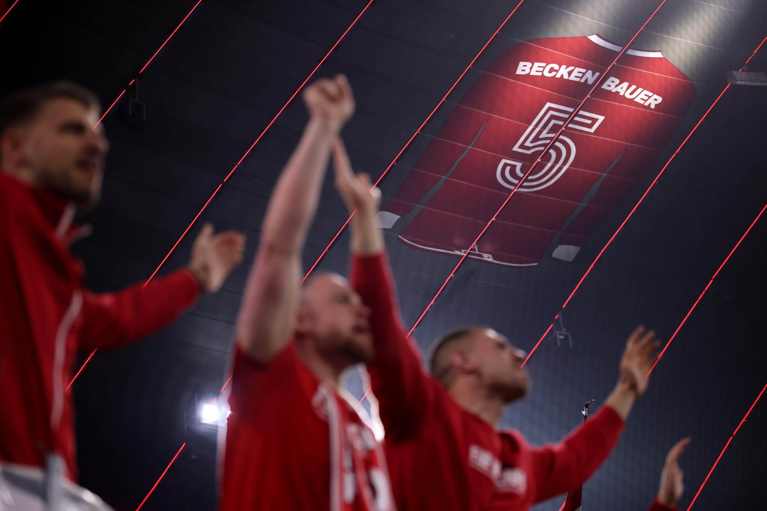 Bayern Munich fans celebrate beneath Franz Beckenbauer's No 5 shirt at the Allianz Arena