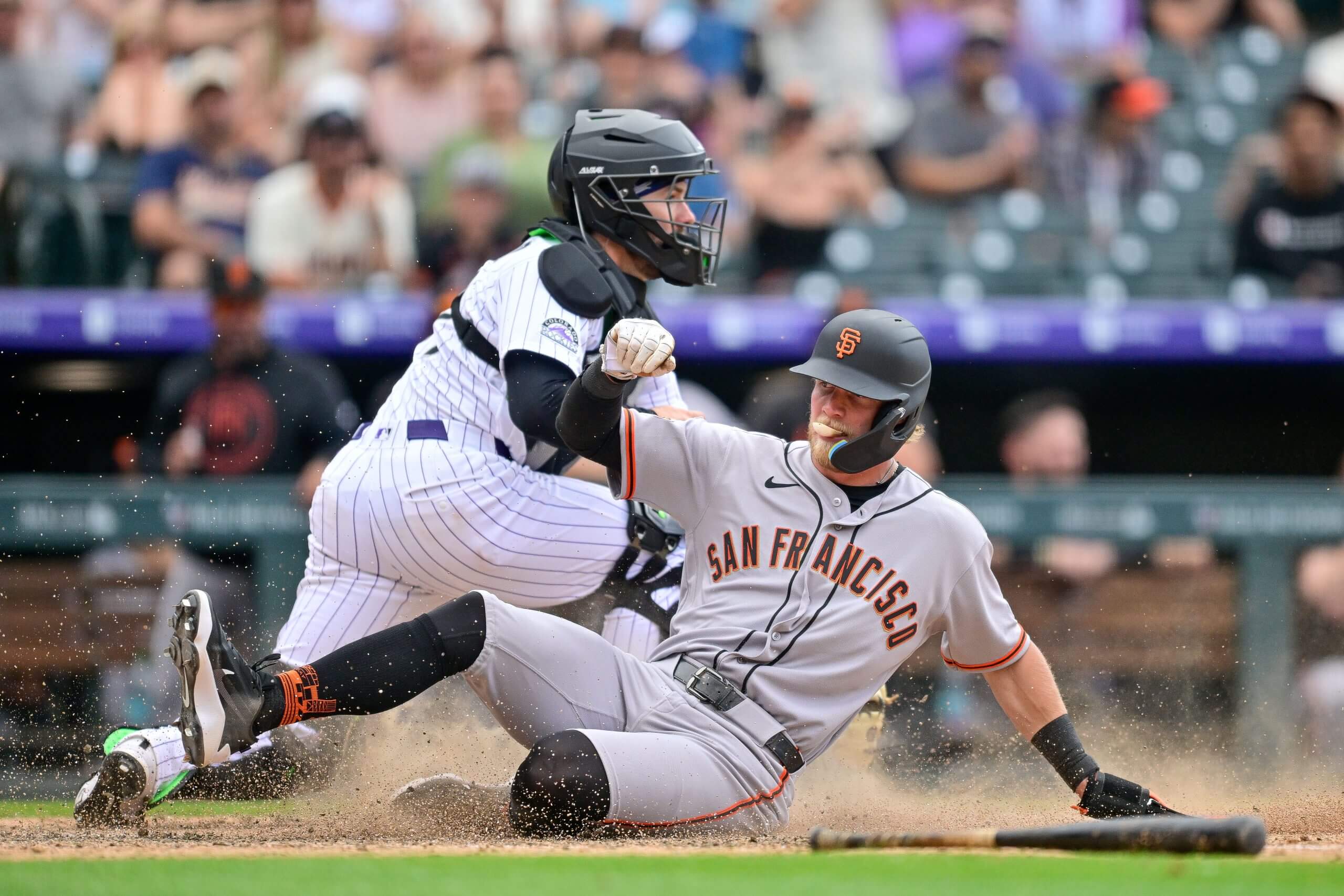Jonah Cox slides into home plate against the Rockies.
