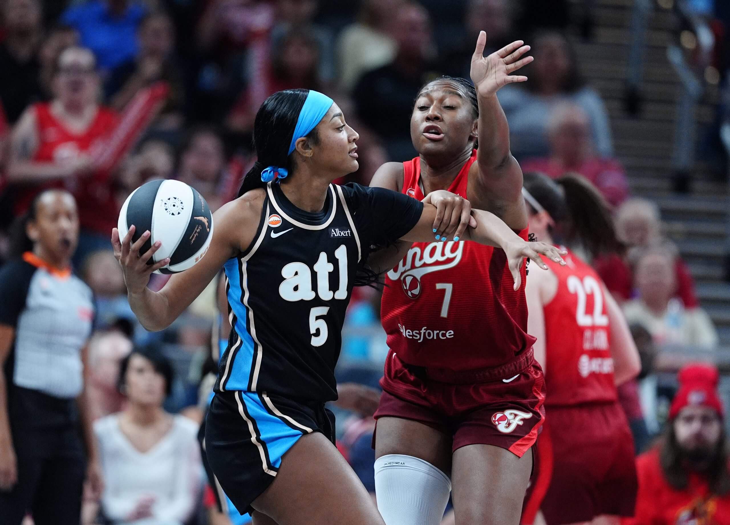 Angel Reese is guarded by Fever center Aliyah Boston.