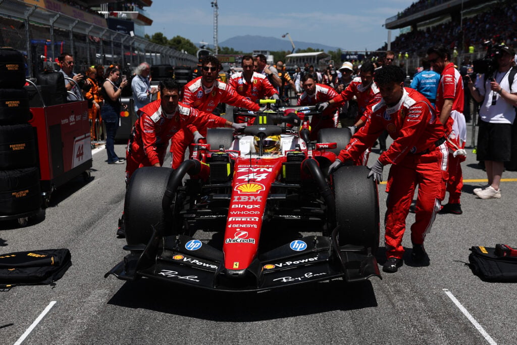 Ferrari mechanics push Lewis Hamilton onto the Barcelona Grand Prix grid