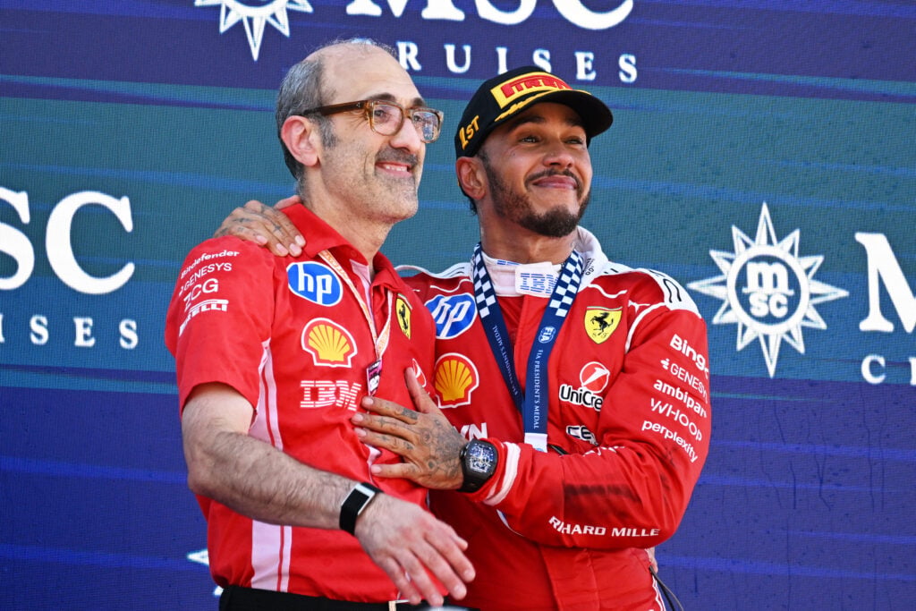 Lewis Hamilton of Ferrari stands on the Barcelona Grand Prix podium with engineer Carlo Santi
