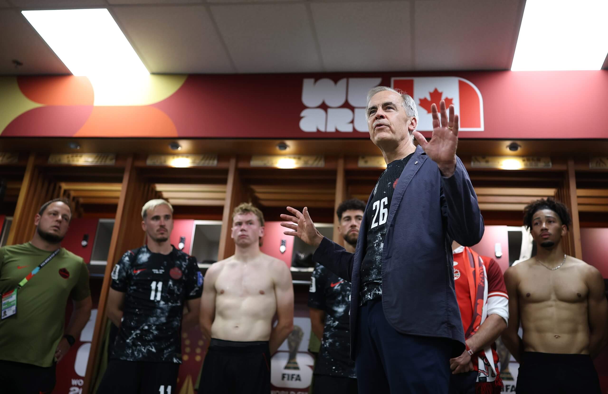 Mark Carney addresses the Canada players in the locker room