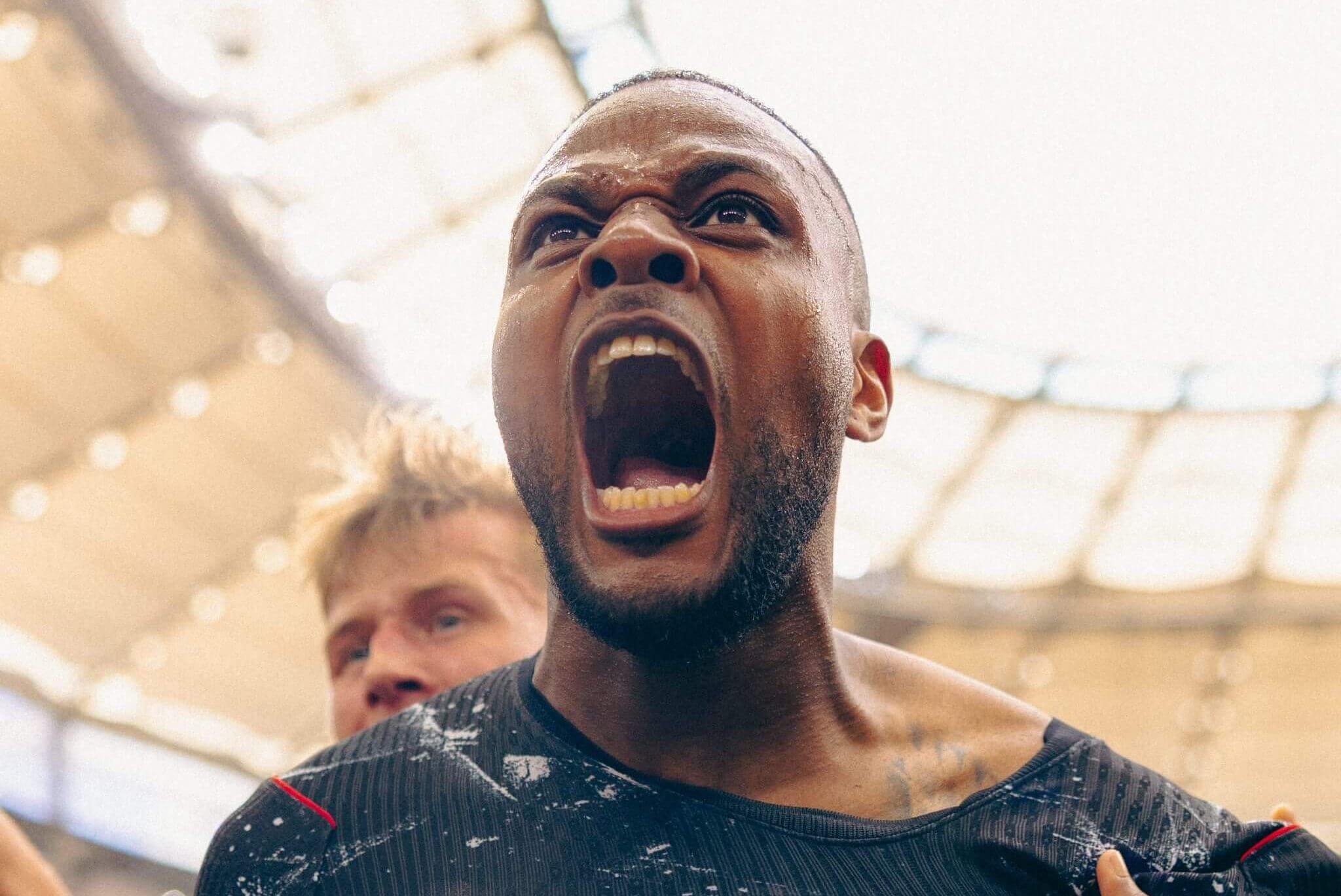 A close-up of a footballer screaming