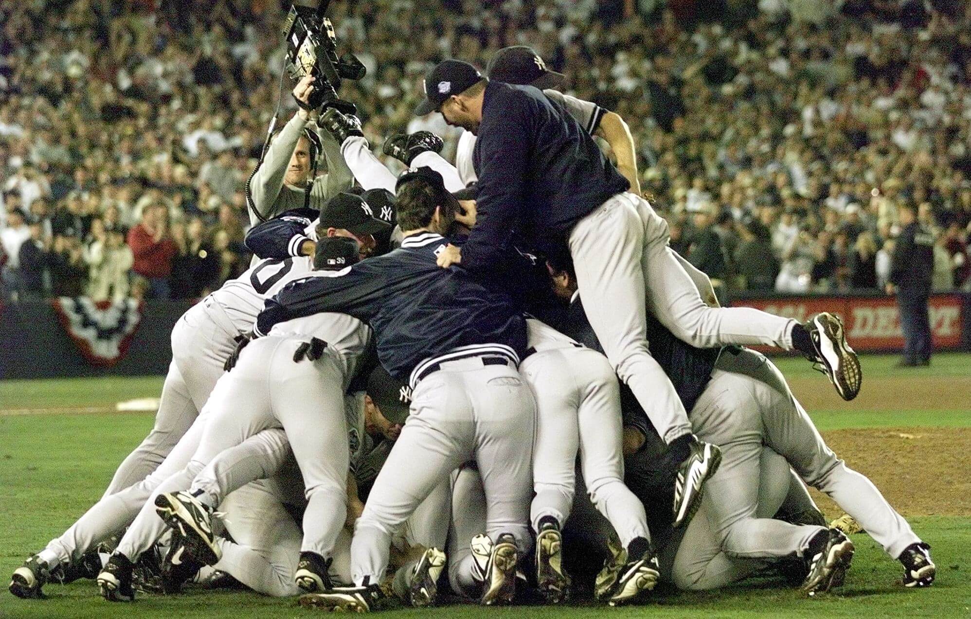 The 1998 Yankees celebrate after sweeping the San Diego Padres in the World Series. (Jeff Haynes / AFP via Getty Images)