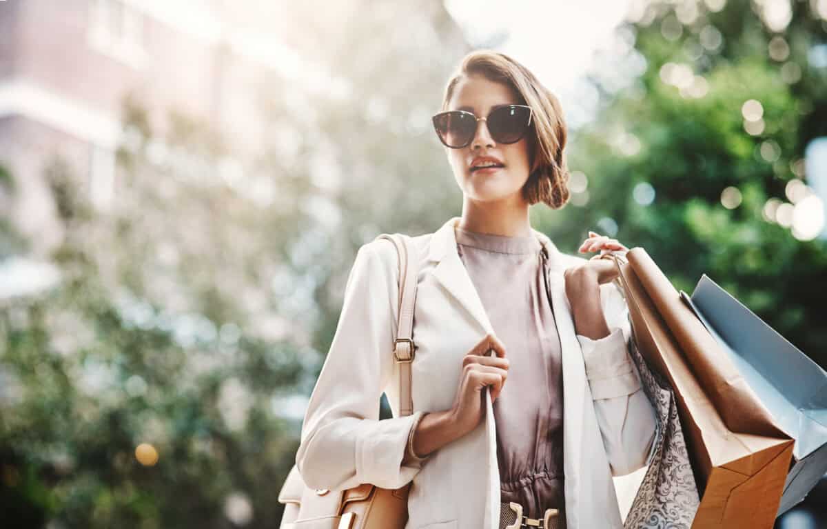 shopper carries paper bags with purchases