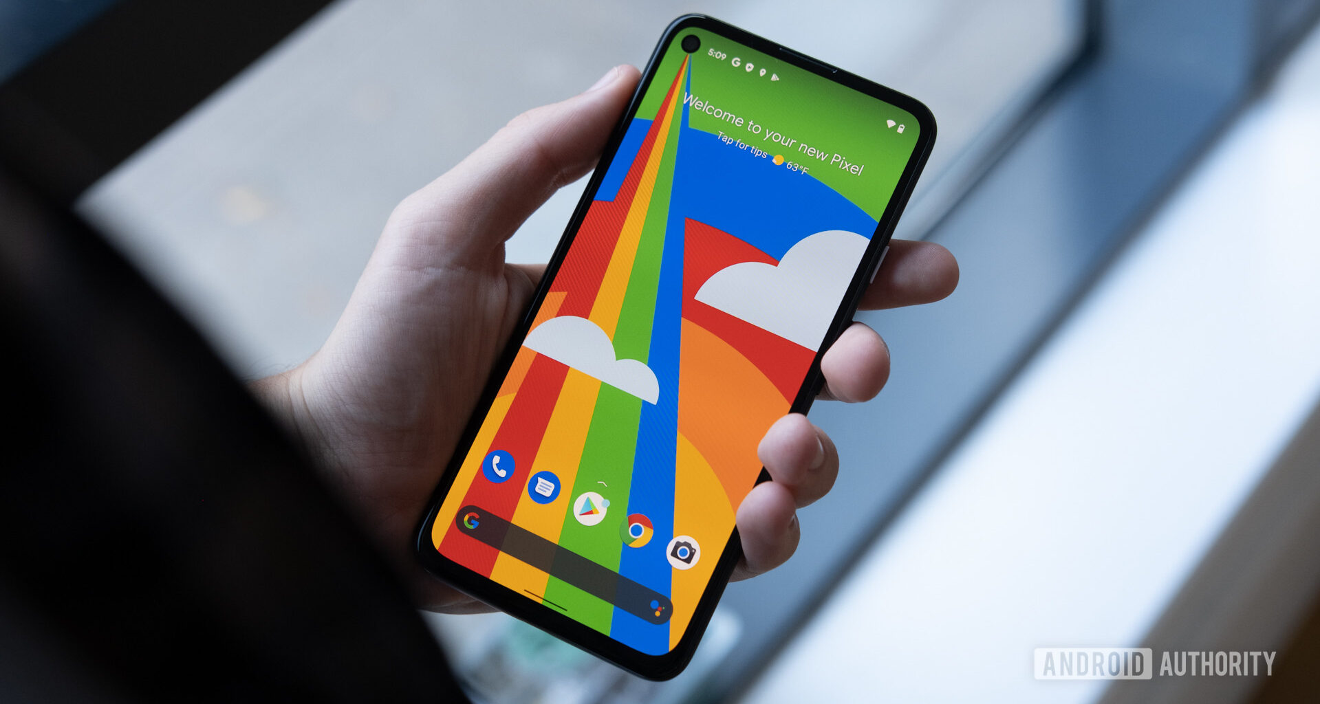 Google Pixel 4a 5G in hand front of phone 2