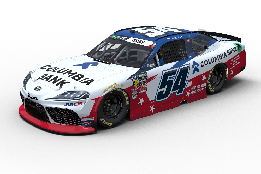 White, red, and blue NASCAR-style race car with number 54 and Columbia Bank branding, angled front-left view of the car.