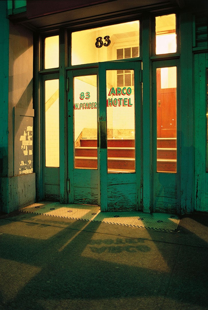 Doorway of an old hotel, illuminated at night.
