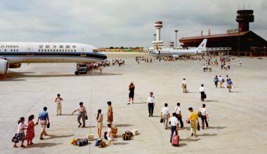 People walking to and from passenger planes on an airport tarmac.