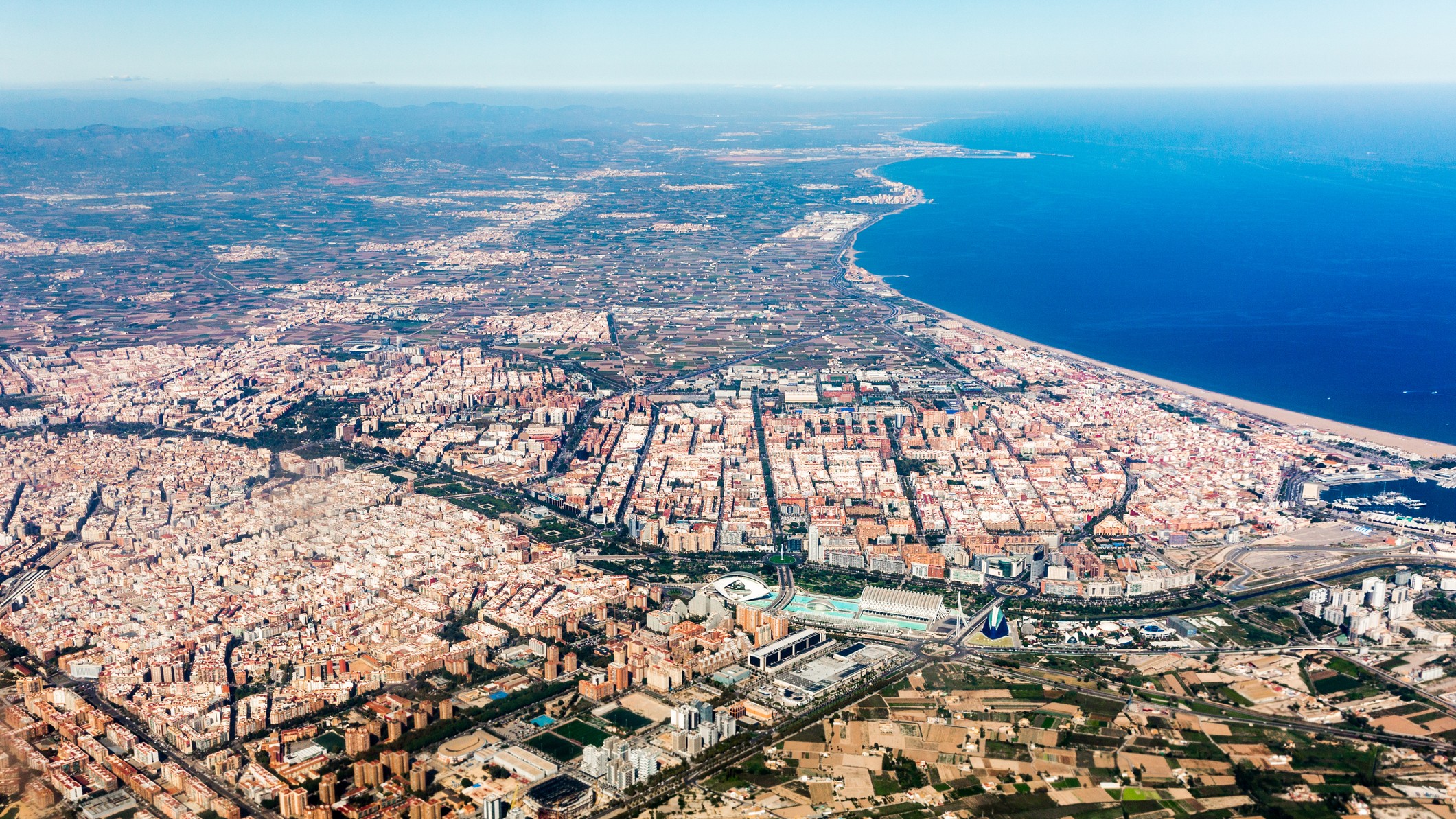aerial view of valencia, spain, deep blue sea on the right.