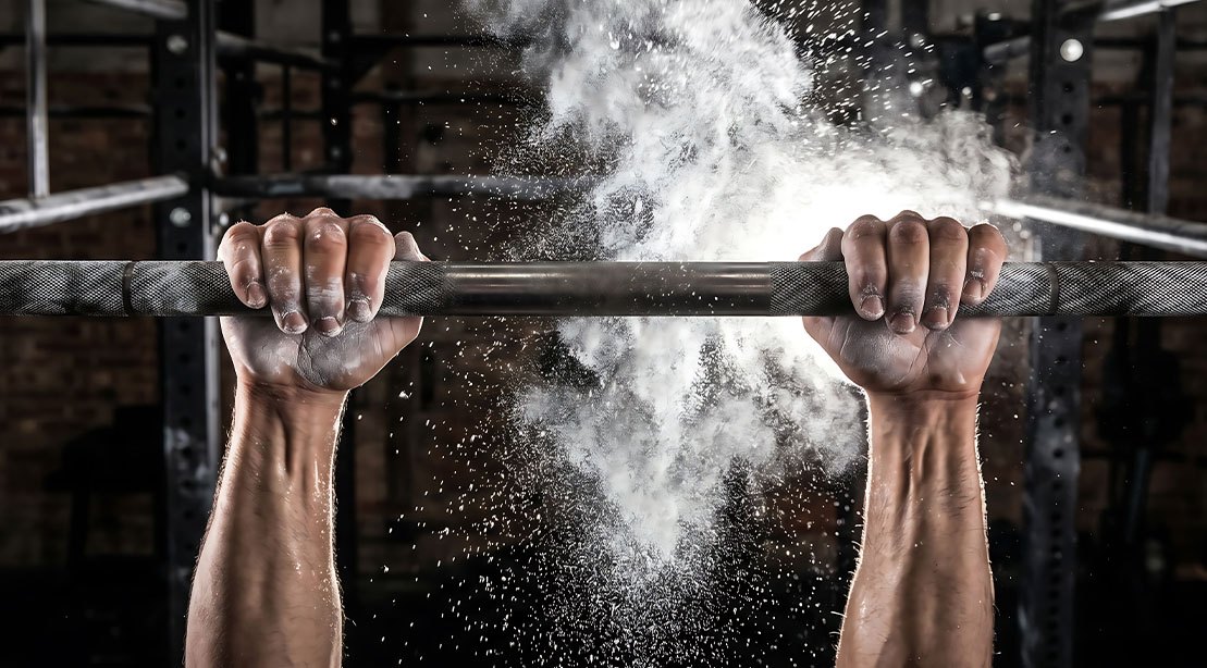 Hands gripping a pullup bar