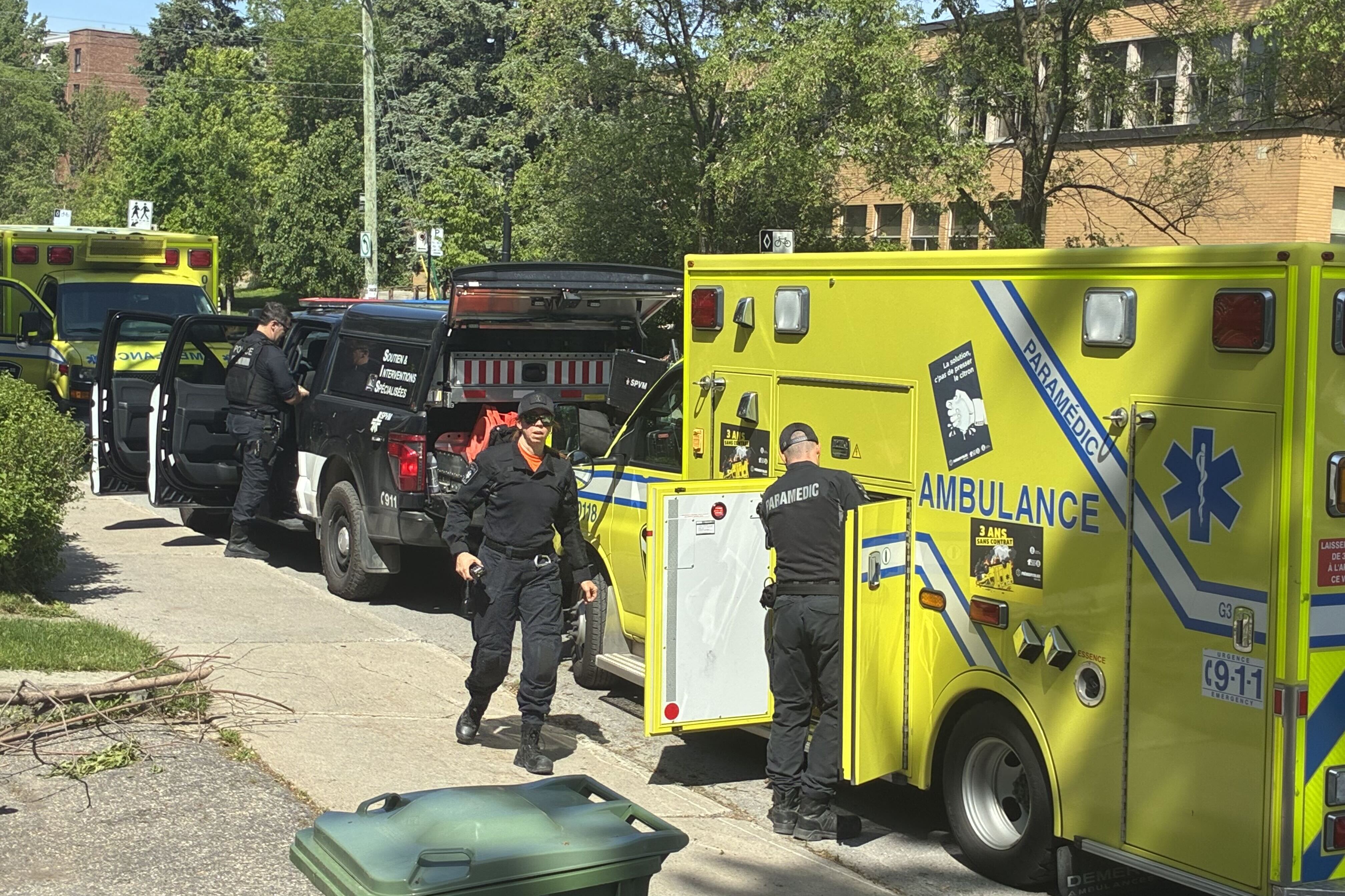 An ambulance and police cars outside a school.
