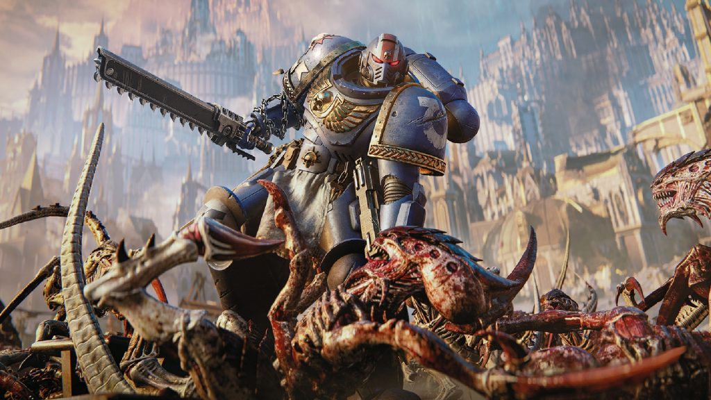 Lieutenant Titus from Space Marine 2 is showing climbing over a group of alien Tyranids with a chainsword in his right hand