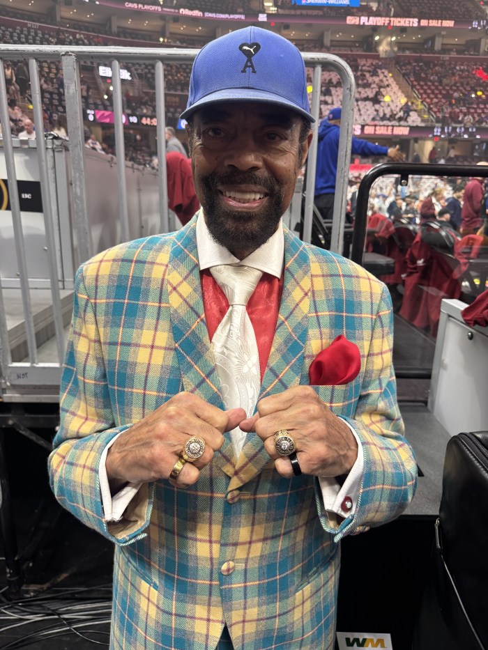 Walt Frazier showing off his rings on both hands.