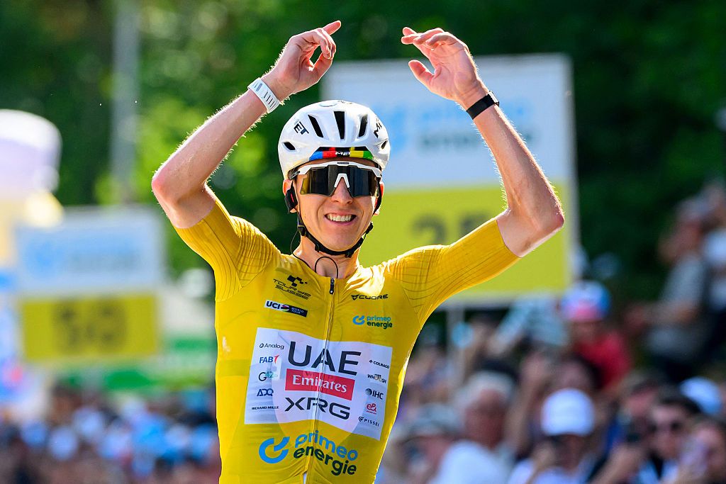 Tadej Pogacar celebrates as he crosses the finish line to win the fifth and final stage of the Tour de Suisse