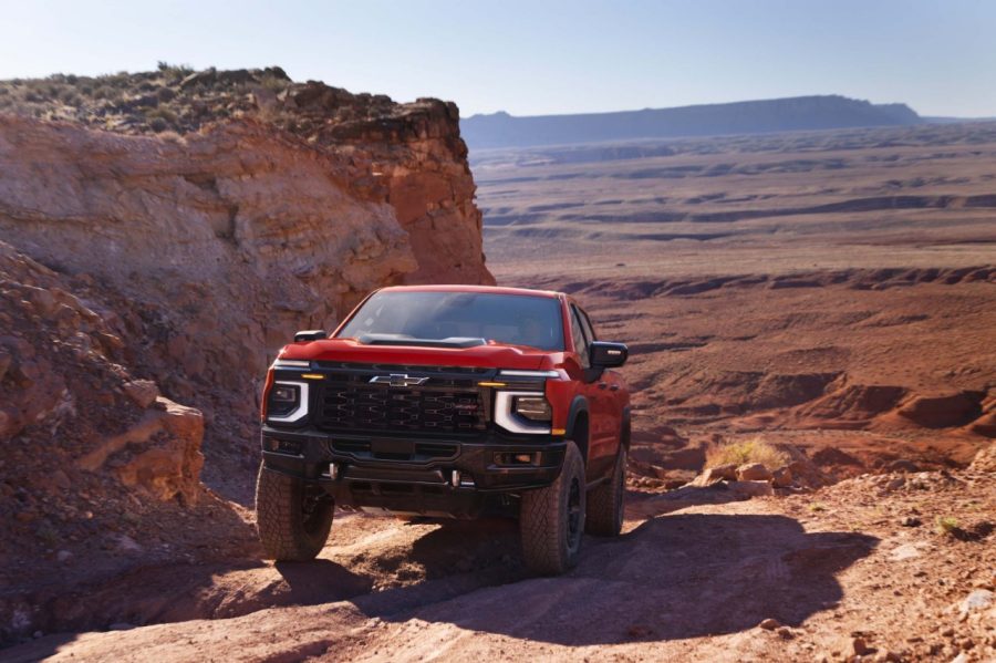 2027 Chevrolet Silverado 1500 ZR2 Bison in Apex Red shown in a desert setting. 2027 Chevrolet Silverado 1500 ZR2 Bison