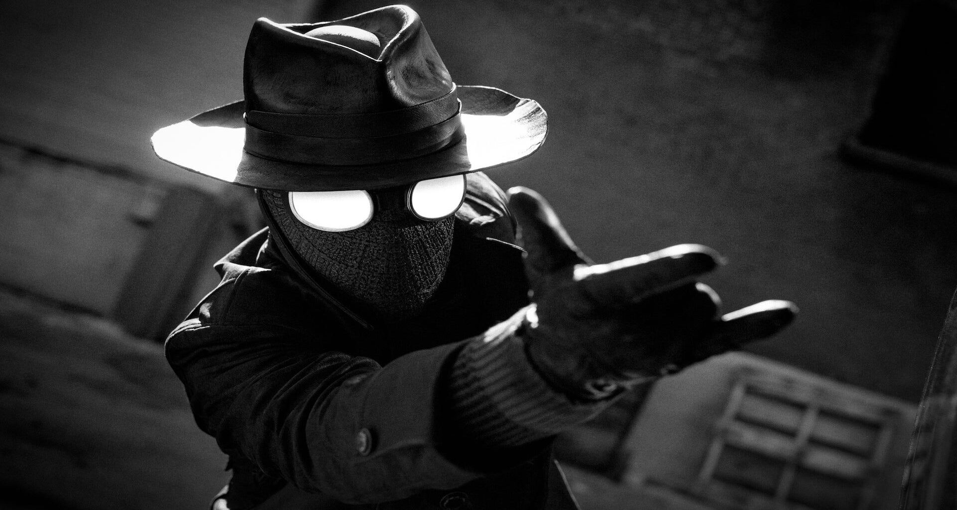 a black-and-white superhero in hat and goggles