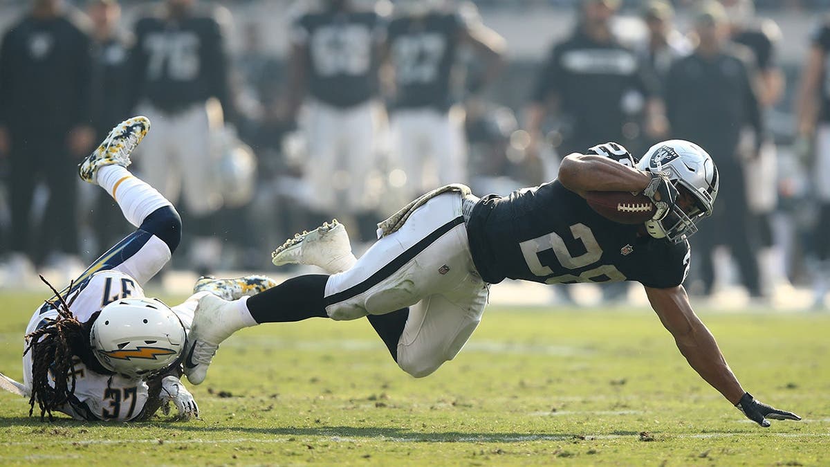 Doug Martin is tackled by Jahleel Addae during an NFL game