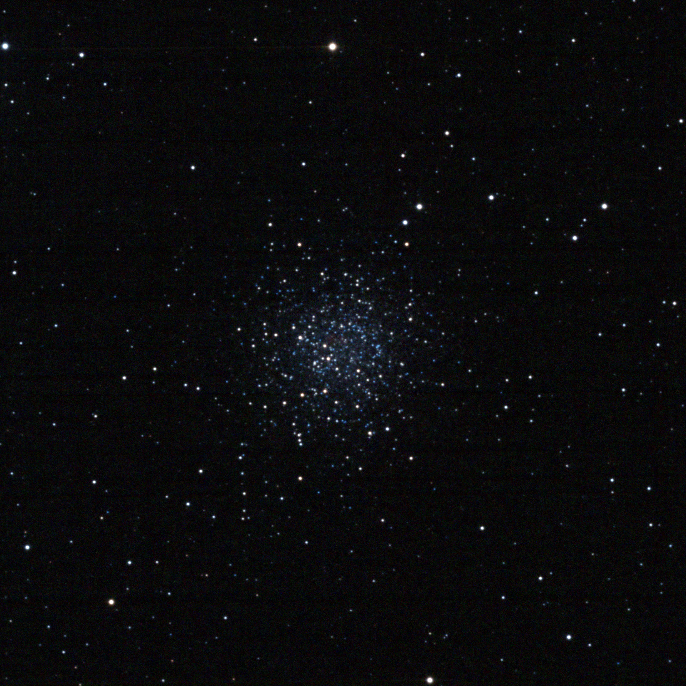 Astrophotograph of NGC 5897, a loose globular cluster appearing as a diffuse, sparkling ball of hundreds of stars — predominantly blue-white — against a black sky background.