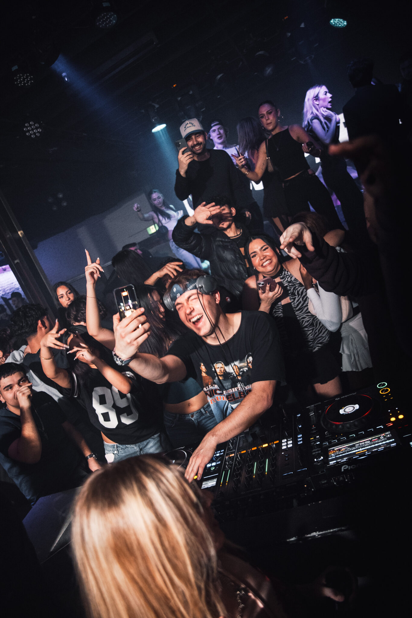 People dancing beside a DJ