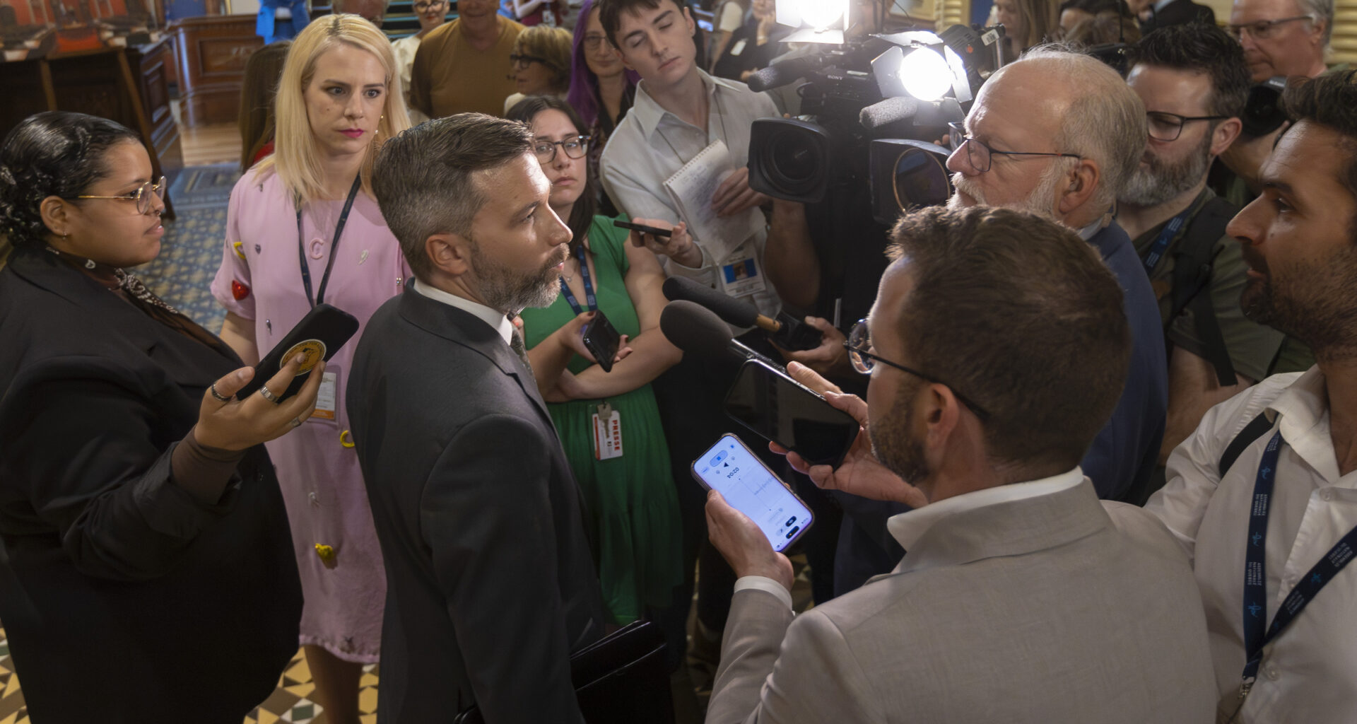 Gabriel Nadeau-Dubois in a media scrum as seen from slightly above.