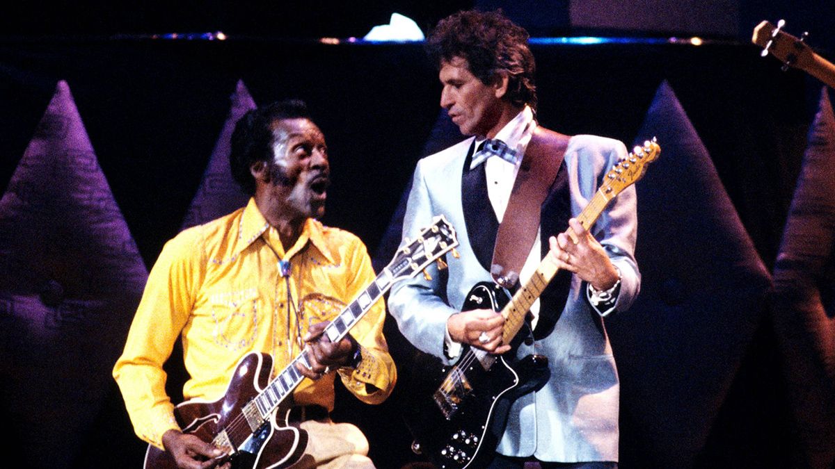 Photo of Chuck BERRY and Keith RICHARDS; Chuck Berry and Keith Richards performing on stage at Chuck's 60th Birthday Concert for the filming of "Hail Hail Rock &amp; Roll"