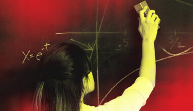 woman erasing math equations from a chalkboard