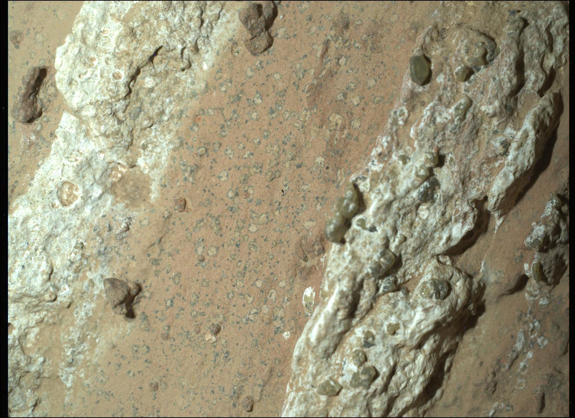 A close up of a series of rock formations on a reddish brown surface.