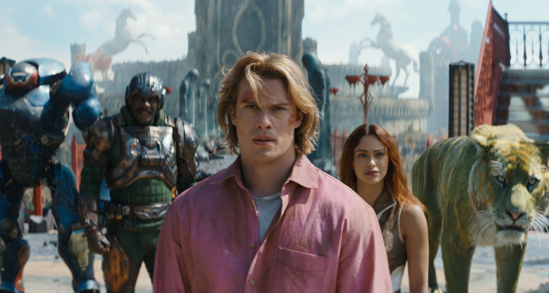 (l-r): Roboto (Kristen Wiig), Man At Arms (Idris Elba), Adam (Nicholas Galitzine), Teela (Camila Mendes) and Cringer in MASTERS OF THE UNIVERSE.