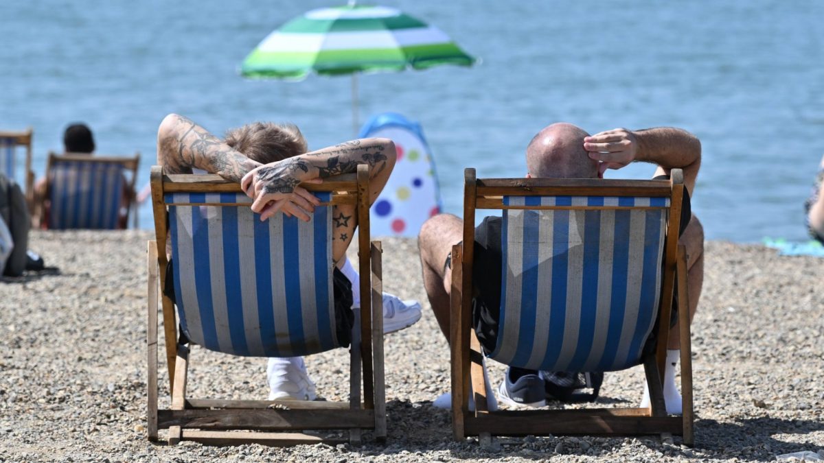SOUTHEND, ENGLAND - MAY 25: Two men relax in deck chairs on Jubilee beach during the hot weather on May 25, 2026 in Southend, England. An exceptional bank holiday heatwave is currently bringing record-breaking weather to England with temperatures forecast to climb into the low 30s by Monday. The intense high pressure has prompted the UK Health Security Agency (UKHSA) to issue rare, amber heat alerts across multiple regions due to the health risks for vulnerable people and extreme UV levels. (Photo by John Keeble/Getty Images)