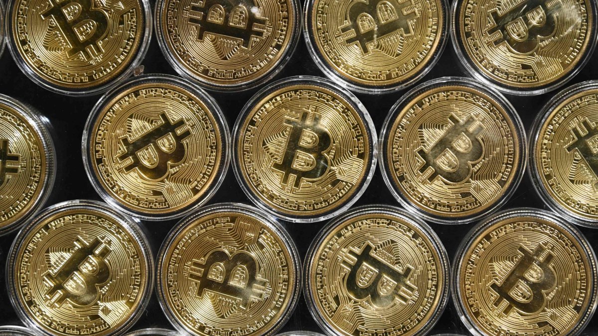 (FILES) File photo taken on September 24, 2020 showing a physical imitation of a Bitcoin at a crypto currency 