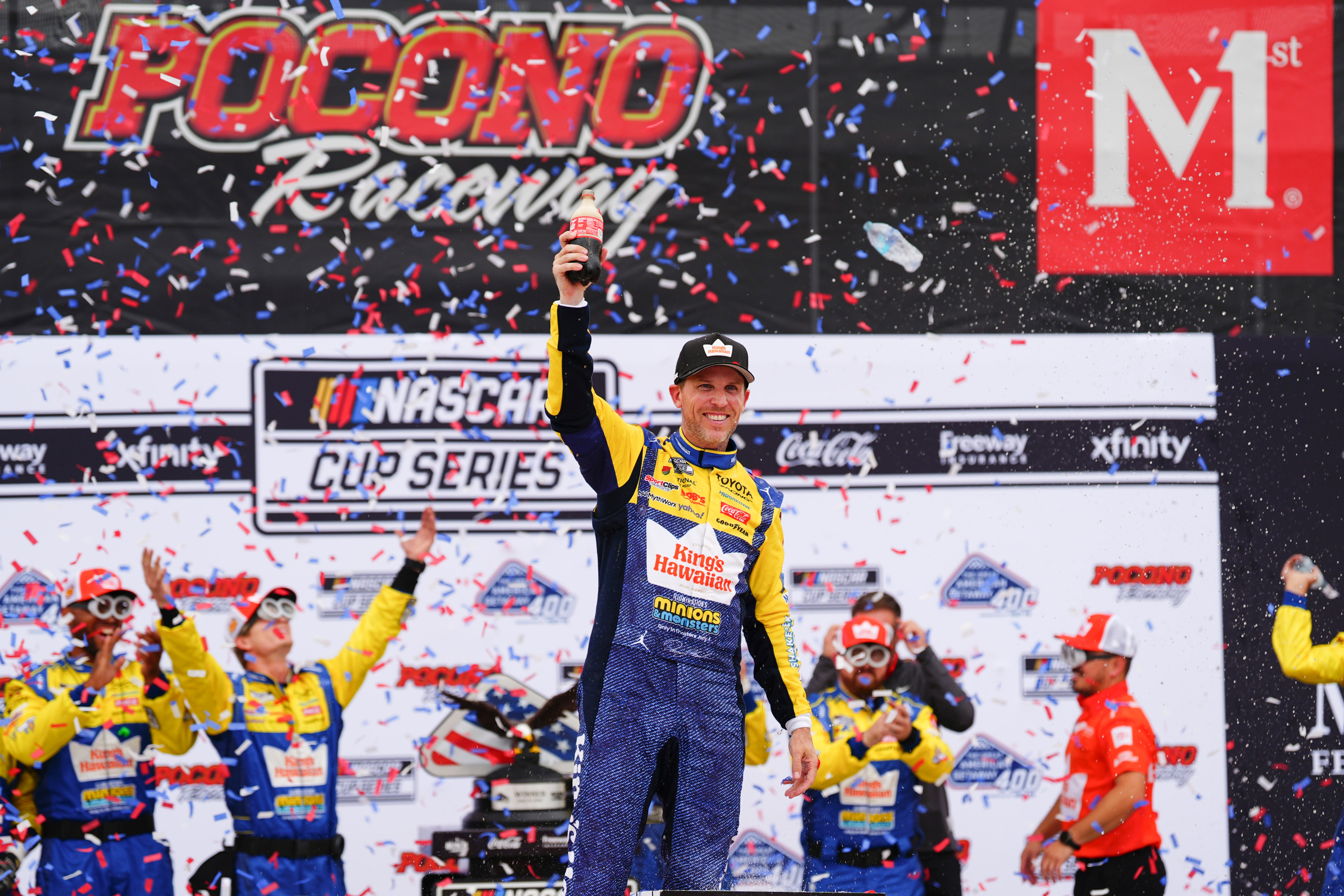 Denny Hamlin celebrates in Victory Lane after winning a NASCAR...