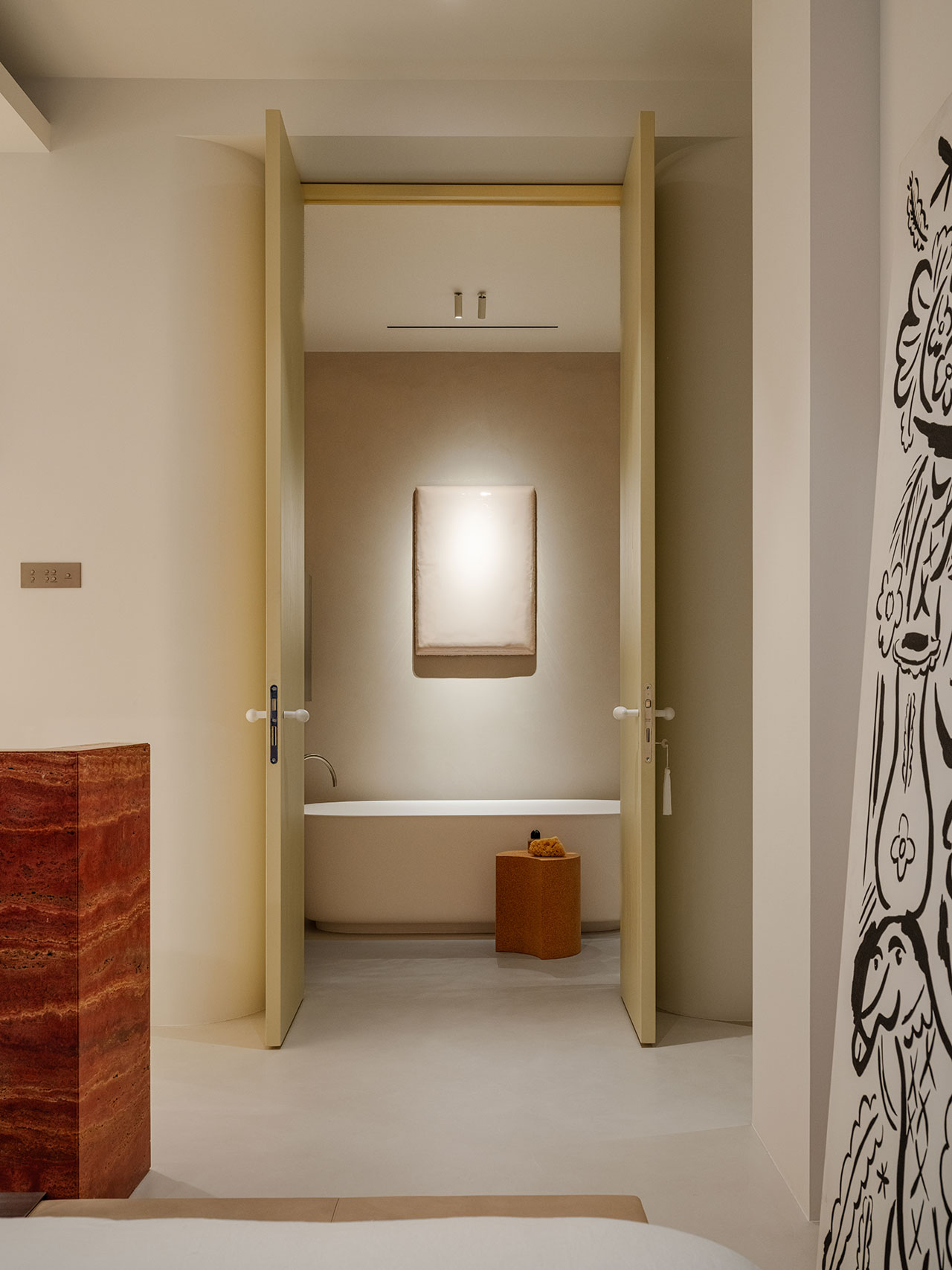 A modern Antwe bathroom with a beige bathtub is visible through open double doors; the space features minimalist decor and soft indirect lighting.