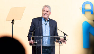Dr. Ken Duckworth speaking at a podium during NAMICon