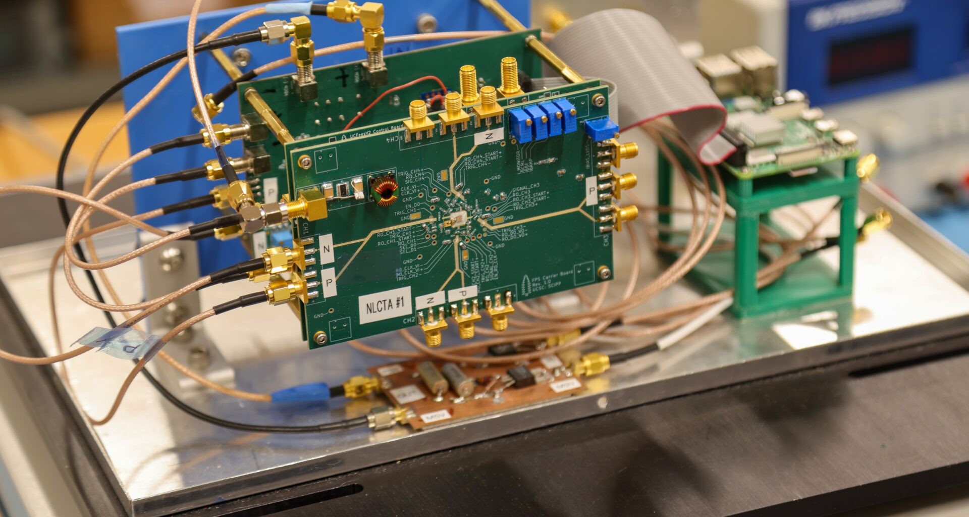 An electronic detection system setup featuring a green printed circuit board.