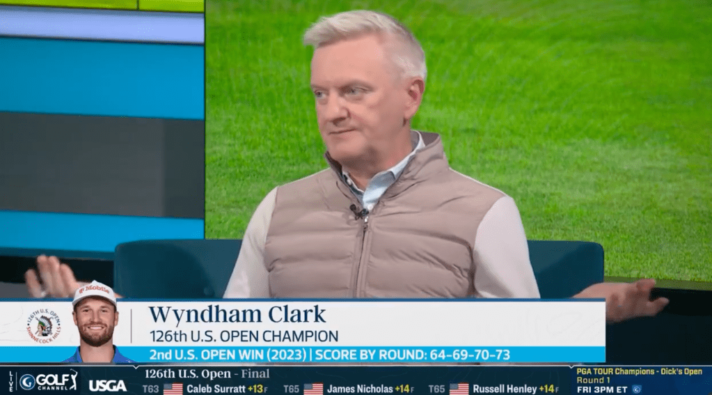 A male sports commentator on a TV screen with a golf tournament scoreboard.