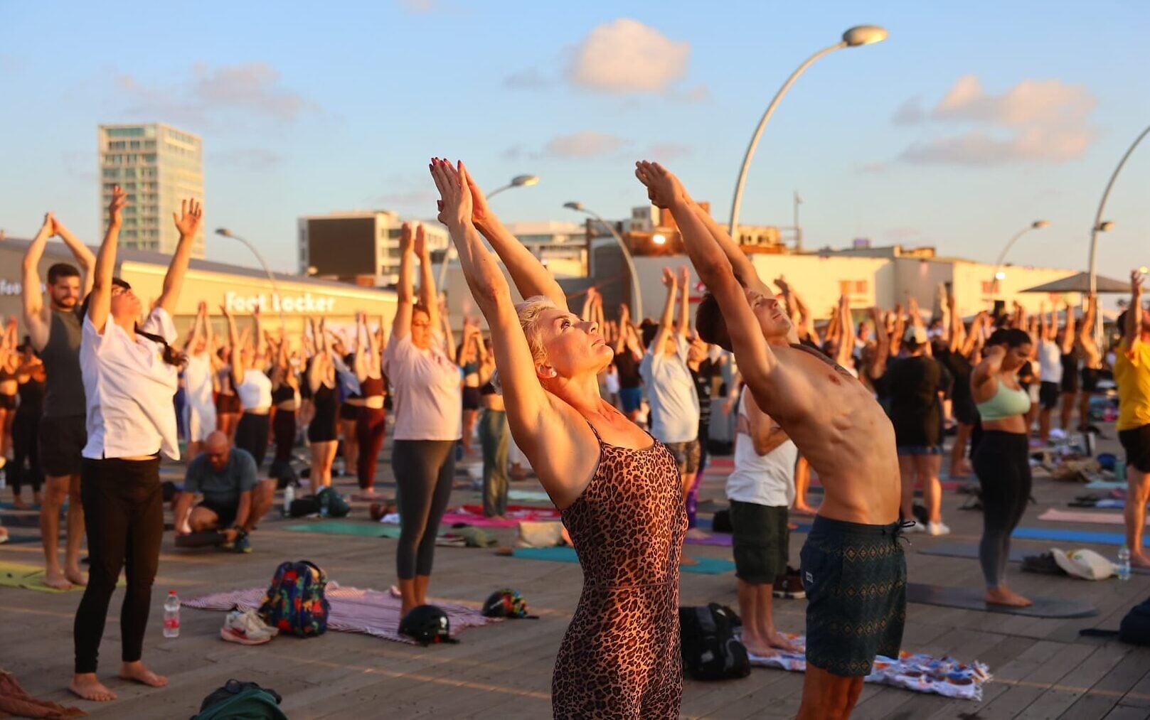 Yoga enthusiasts salute the Tel Aviv sun
