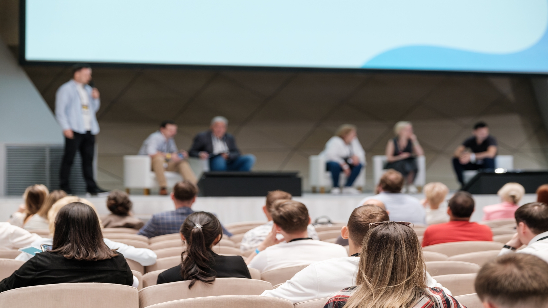 Tech conference featuring speakers on stage