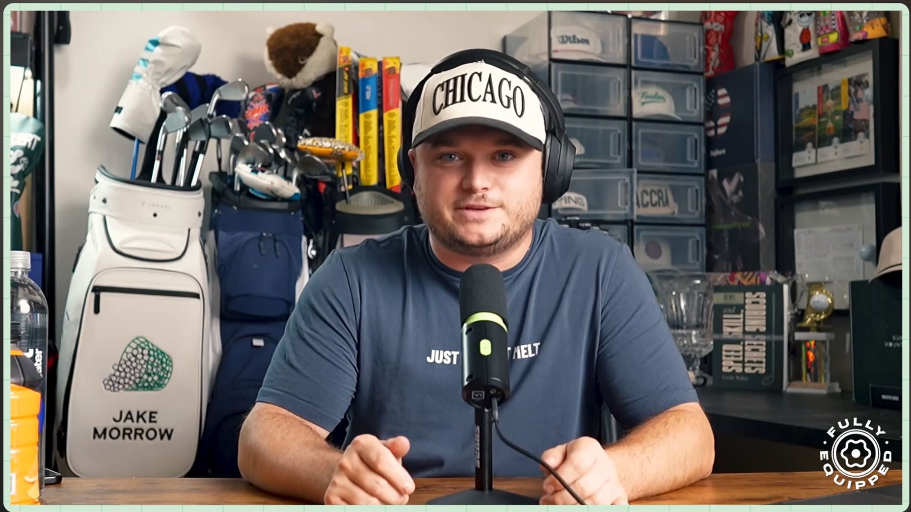 A man wearing a CHICAGO hat and headphones sits at a desk with a microphone. Behind him are golf bags, shelves with storage boxes, and various items. A logo reading FULLY EQUIPPED is in the lower right corner.