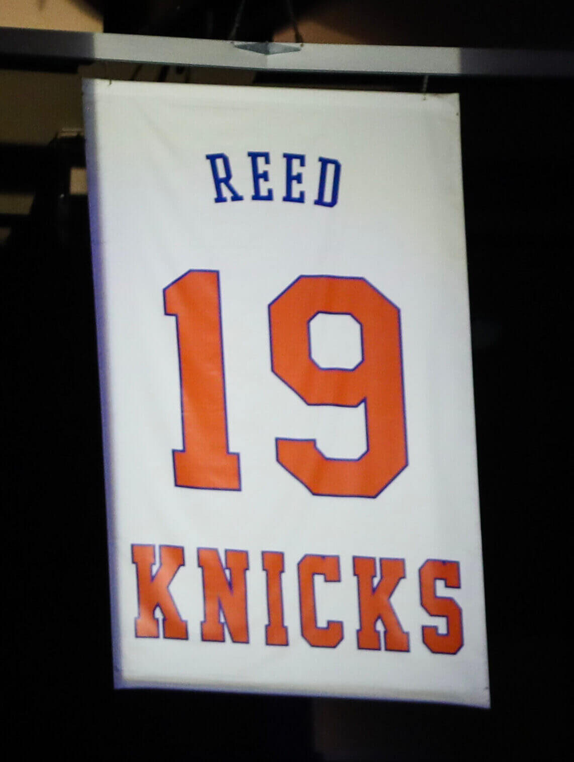 Willis Reed's No. 19 banner is lit up at Madison Square Garden in 2023.