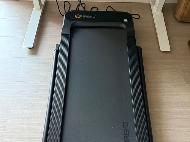 Overhead view of Urevo Strol 2S Pro Treadmill, a black walking pad underneath a standing desk