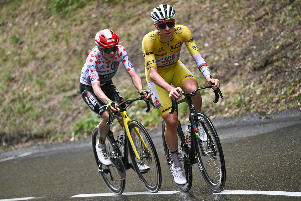 UAE Team Emirates - XRG team's Slovenian rider Tadej Pogacar wearing the overall leader's yellow jersey and Team Visma - Lease a bike team's Danish rider Jonas Vingegaard wearing the best climber's polka dot (dotted) jersey cycle in the final ascent of La Plagne during the 19th stage of the 112th edition of the Tour de France cycling race, 93.1 km between Albertville and La Plagne, in the French Alps, on July 25, 2025. The 19th stage of the Tour de France was shorted from its initial 129.9 km route, bypassing the Col des Saisies where an outbreak of nodular dermatitis in a herd of cattle was discovered, prompting organizers to modify the race route. (Photo by Marco BERTORELLO / AFP)