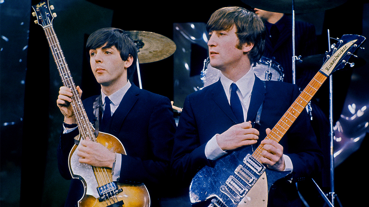 British Rock musicians Paul McCartney (left) and John Lennon (1940 - 1980), of the group the Beatles, perform on the set of 'The Ed Sullivan Show' at CBS's Studio 50, New York, New York, February 8, 1964. The photo was taken during rehearsals for the group's debut performance on the show the following day. Note that the backdrop was very different from the one used in the broadcast.