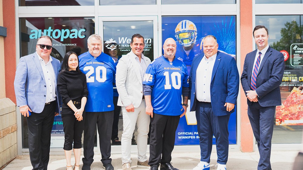 Guests including (from L to R): Western Financial Group’s Craig Kozlowski, Chief Information and Technology Officer; Michelle Mak, Director, Western Communities Foundation; Darren Sinclair, Senior Vice President, National Branch Network; Grant Ostir, Chief Executive Officer; Mike Chapnick, Vice President, Provincial Branch Network; Winnipeg Blue Bombers’ President and CEO Wade Miller; and Manitoba Finance Minister Adrien Sala take part in Western Financial Group’s tailgate-themed community event and branch rebrand celebration in Winnipeg on June 11, 2026.