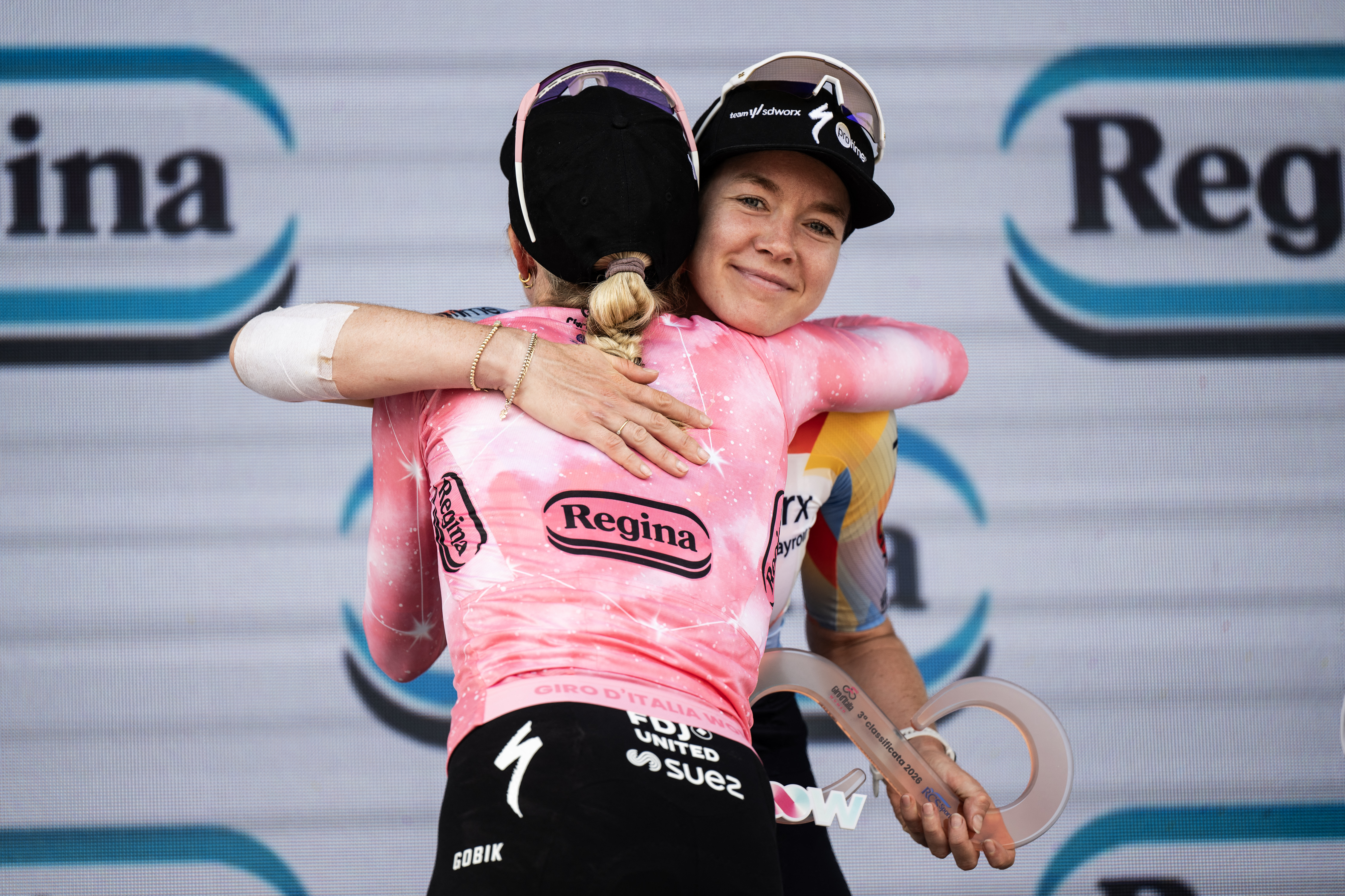 FDJ SUEZ Dutch rider Demi Vollering (C/L) wearing the overall leader's pink jersey and winner of the Giro d'Italia Women 2026 - Tour of Italy cycling race embraces second placed SD Worx Dutch rider Anna Van Der Breggen after the 9th stage of the Giro d'Italia Women 2026 - Tour of Italy Women cycling race between Saluzzo and Saluzzo, Italy, on June 7, 2026. (Photo by MARCO BERTORELLO / AFP via Getty Images)