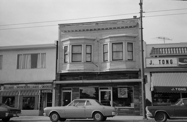 1974: 6035 Fraser St. Visible are the business signs for Fraser Billiards and Snooker, The Salvation Army Thrift Shop, and J. Tong.