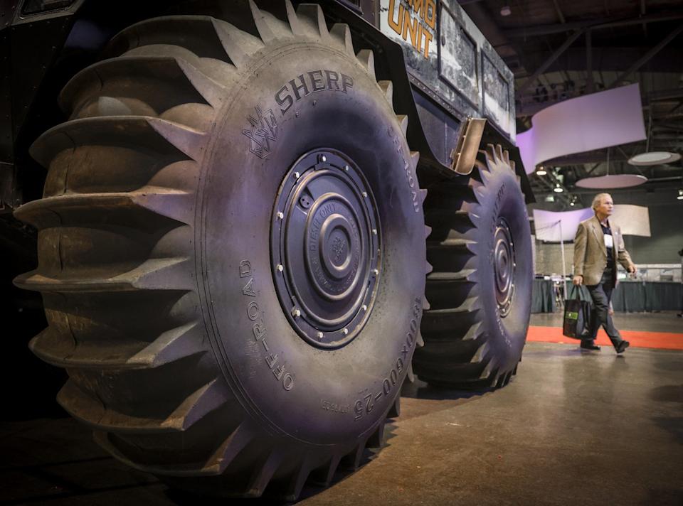 A delegate walks past an all-terrain vehicle at the Global Energy Show in Calgary on Tuesday, June 10, 2025. THE CANADIAN PRESS/Jeff McIntosh - The Canadian Press